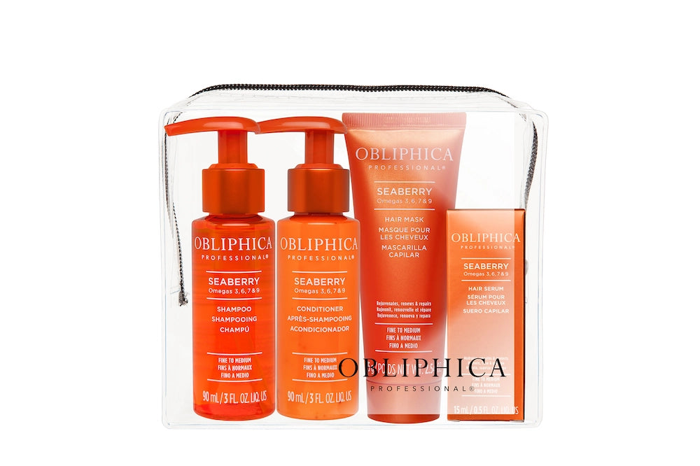 A travel kit containing four OBLIPHICA Seaberry hair care products for fine to medium textures, including shampoo, conditioner, hair mask, and hair serum in TSA-approved bottles.