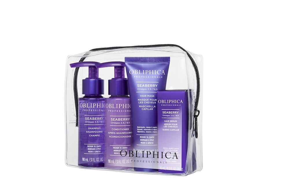 A travel kit containing four OBLIPHICA Seaberry hair care products for medium to coarse textures, including shampoo, conditioner, hair mask, and hair serum in TSA-approved bottles.