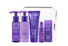 A travel kit containing four OBLIPHICA Seaberry hair care products for medium to coarse textures, including shampoo, conditioner, hair mask, and hair serum in TSA-approved bottles.
